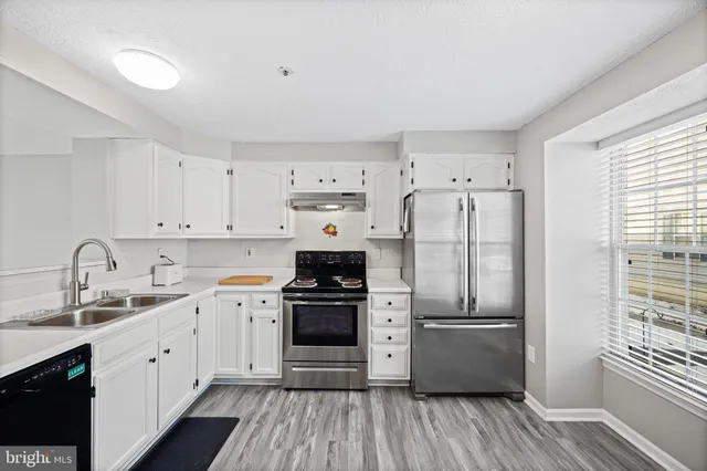 a kitchen with a refrigerator stove and sink