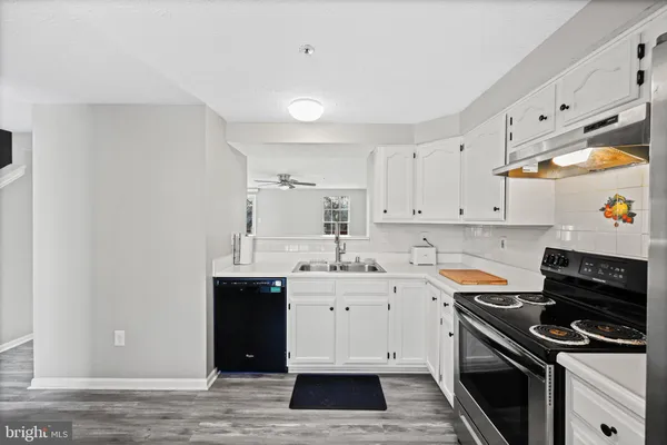 a kitchen with a sink stove and cabinets