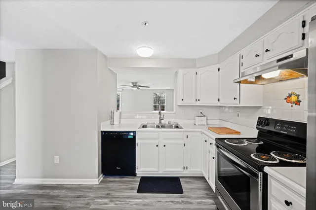 a kitchen with a sink stove and cabinets