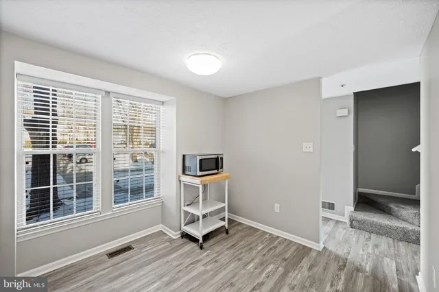 a view of workspace with wooden floor and windows