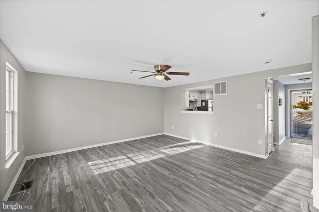 wooden floor in an empty room with a window