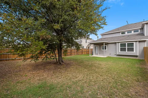 a view of a house with a backyard