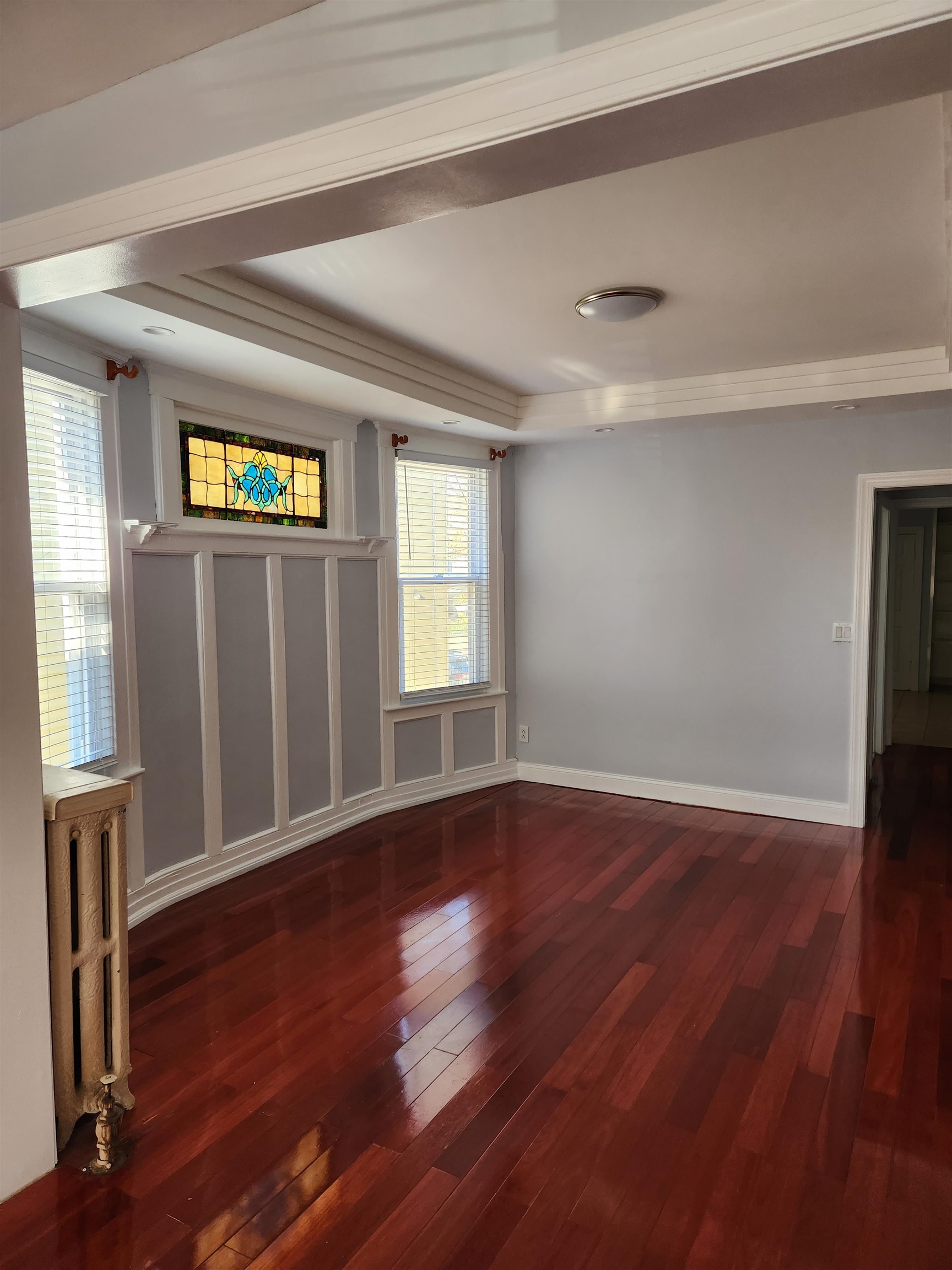 168 Fairview Avenue, Unit 1 Jersey City, NJ 07304 - Photo 13 of 17 a view of an empty room with wooden floor and a window