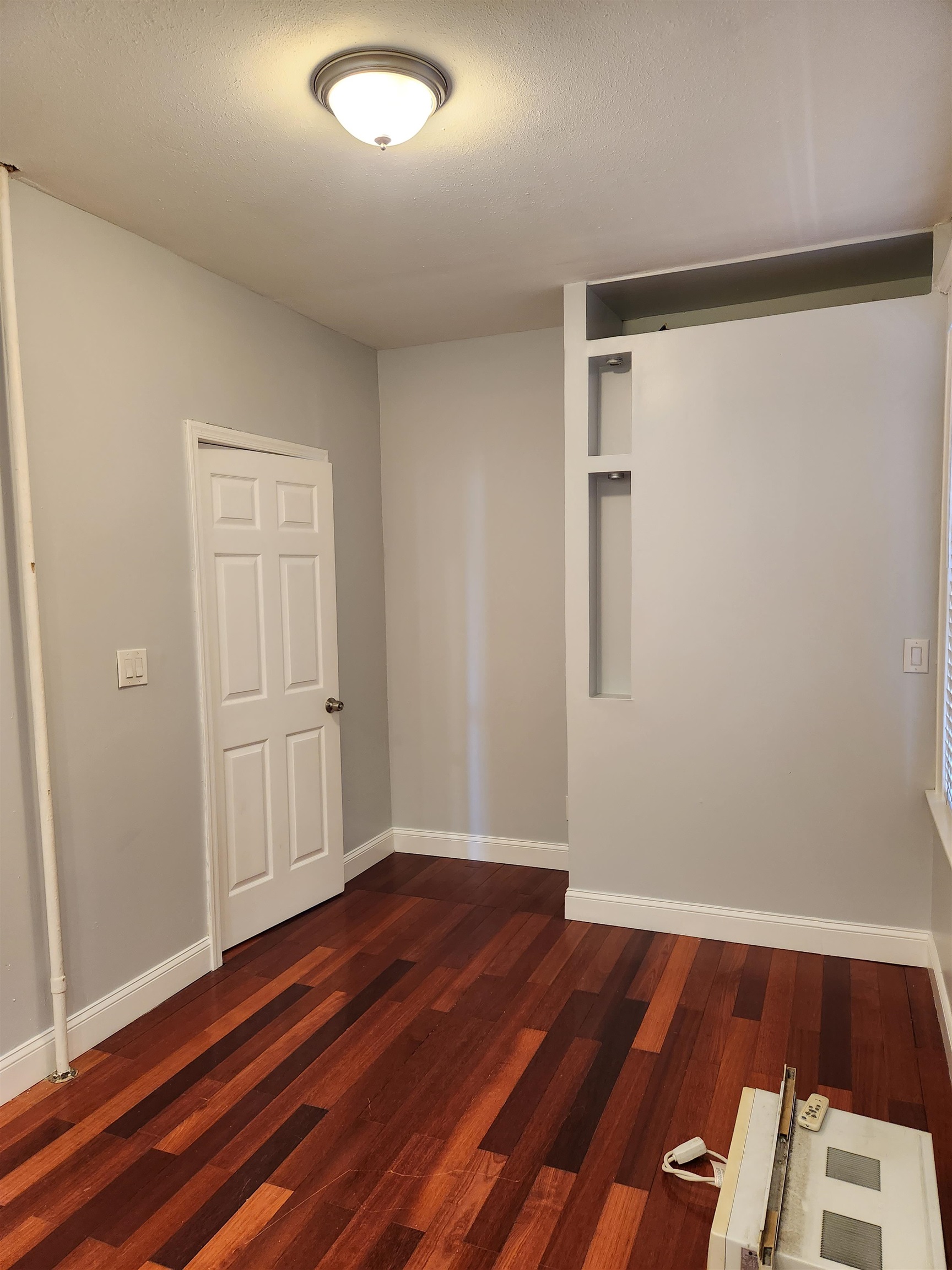 168 Fairview Avenue, Unit 1 Jersey City, NJ 07304 - Photo 14 of 17 an empty room with wooden floor and closet