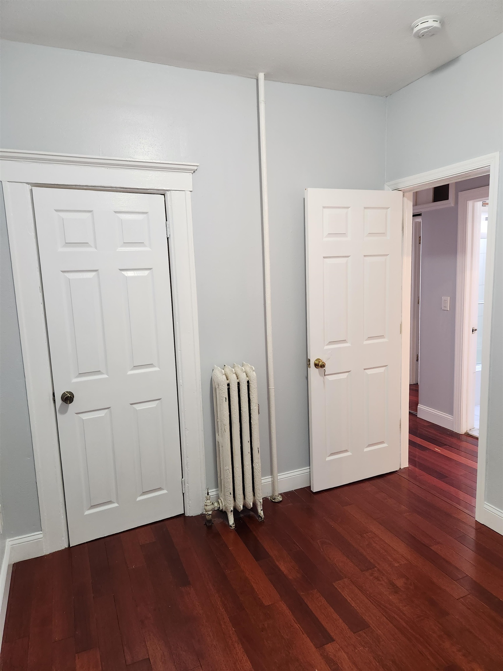 168 Fairview Avenue, Unit 1 Jersey City, NJ 07304 - Photo 17 of 17 an empty room with wooden floor and closet area