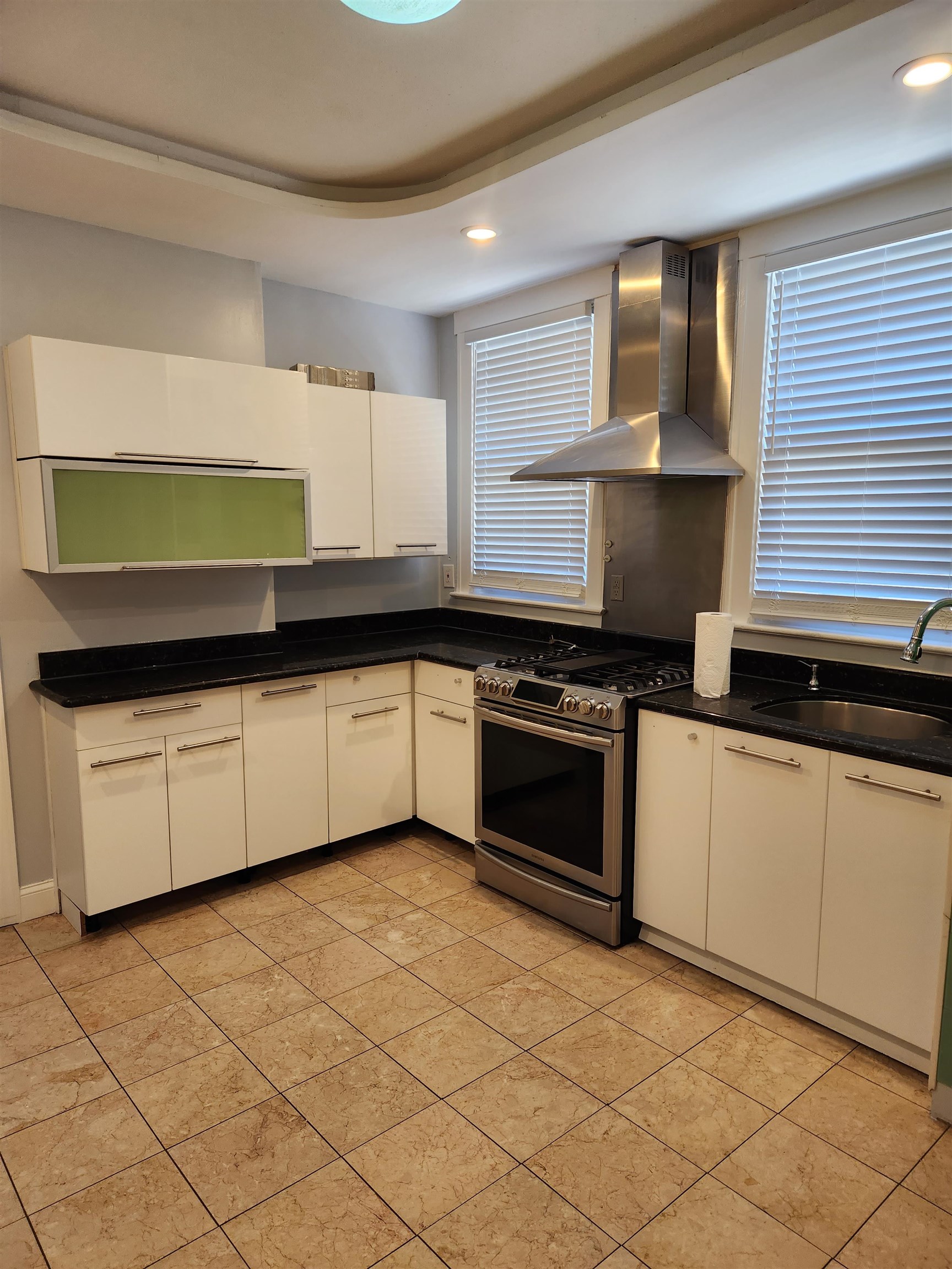 168 Fairview Avenue, Unit 1 Jersey City, NJ 07304 - Photo 3 of 17 a kitchen with granite countertop a sink and a stove