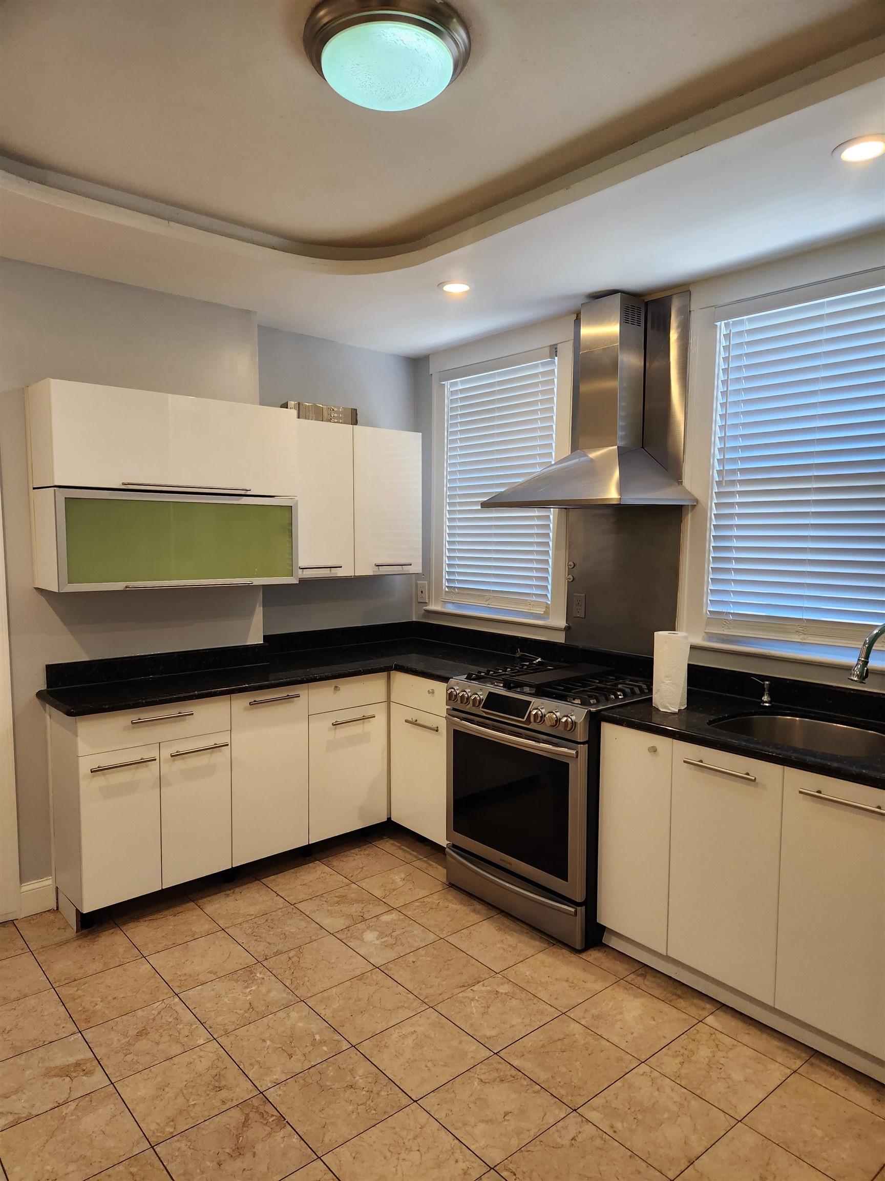 168 Fairview Avenue, Unit 1 Jersey City, NJ 07304 - Photo 5 of 17 a kitchen with granite countertop a sink and a stove