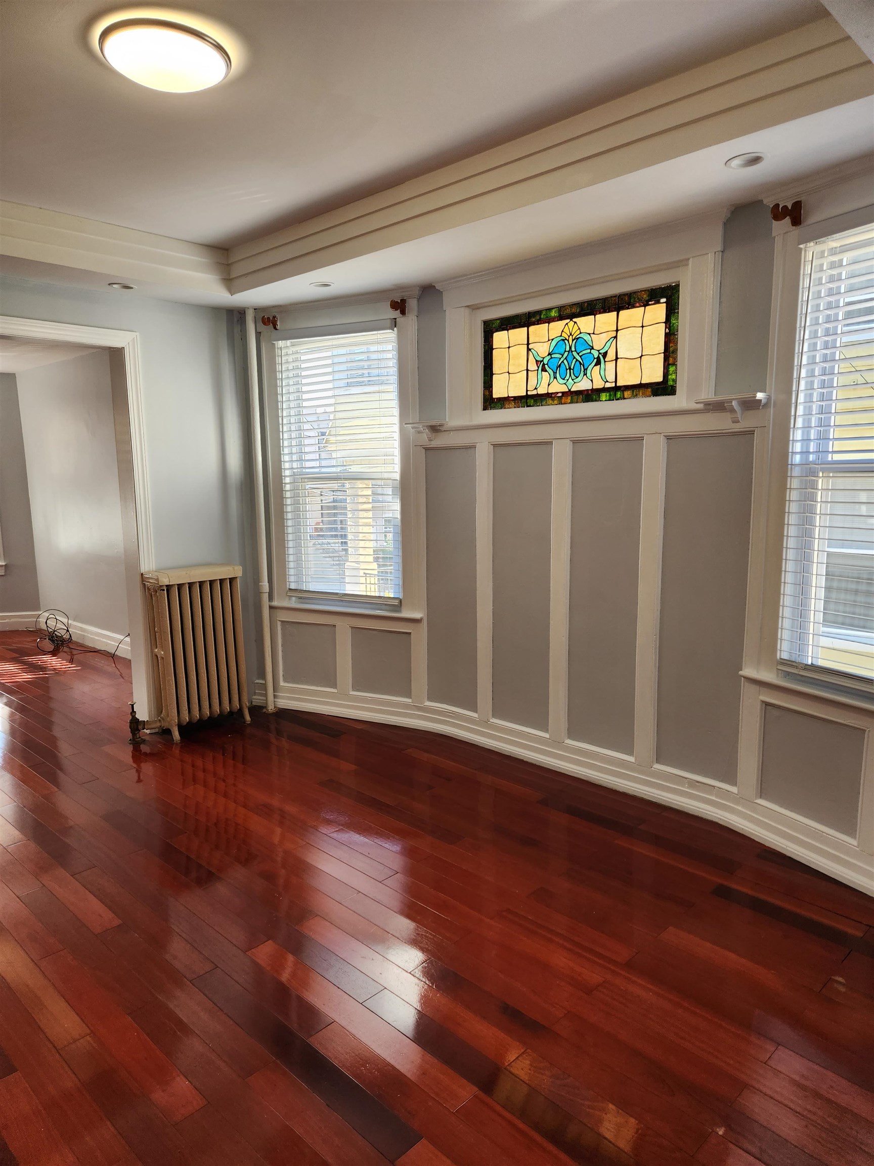 168 Fairview Avenue, Unit 1 Jersey City, NJ 07304 - Photo 8 of 17 a view of an empty room with wooden floor and a window