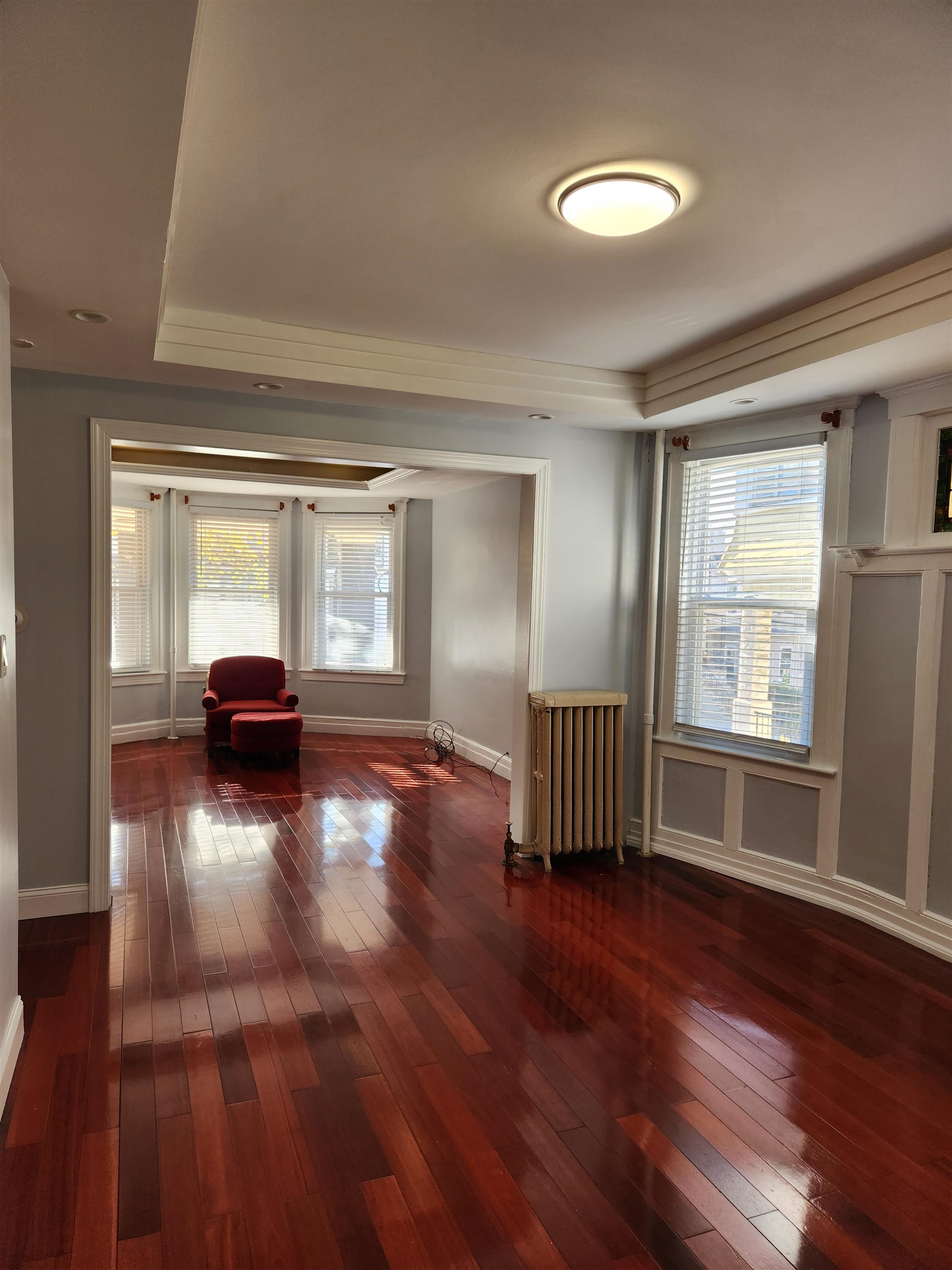 168 Fairview Avenue, Unit 1 Jersey City, NJ 07304 - Photo 9 of 17 a view of empty room with wooden floor and window