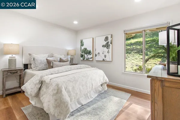 a bedroom with a bed and a large window