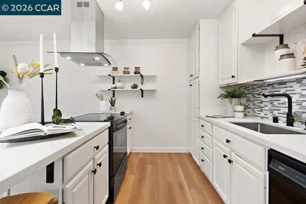 a kitchen with stainless steel appliances granite countertop a sink stove and cabinets