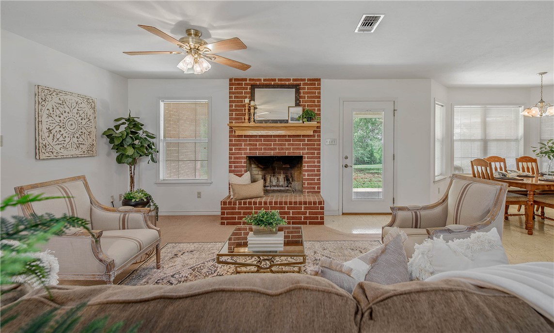 1110 County Road 439 Dime Box, TX 77853 - Photo 10 of 50 a living room with furniture chandelier and a fireplace