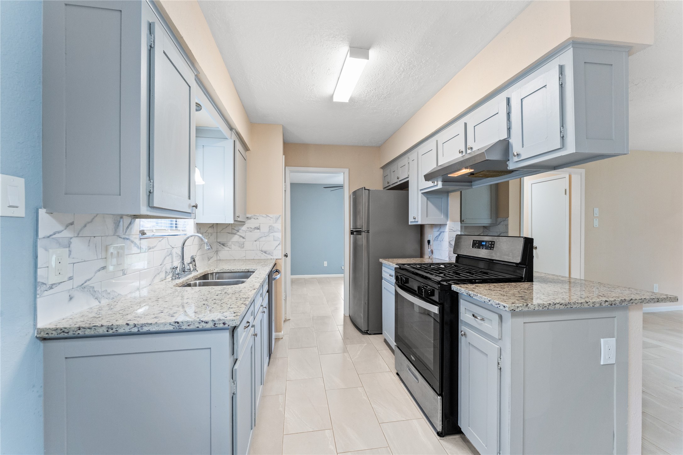1431 Epsilon Street Pasadena, TX 77504 - Photo 8 of 21 a kitchen with stainless steel appliances granite countertop a sink stove and cabinets