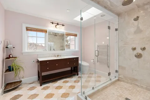 a bathroom with a sink a vanity a mirror and a shower