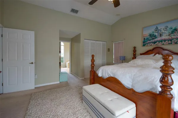 a bedroom with a bed and a lamp