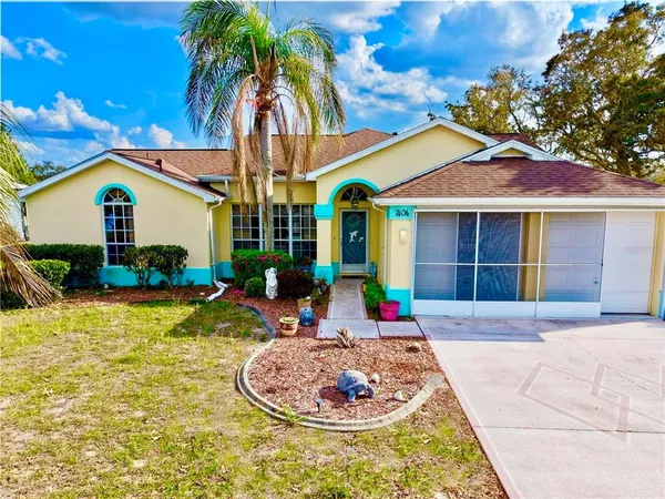 a view of a house with swimming pool and sitting area