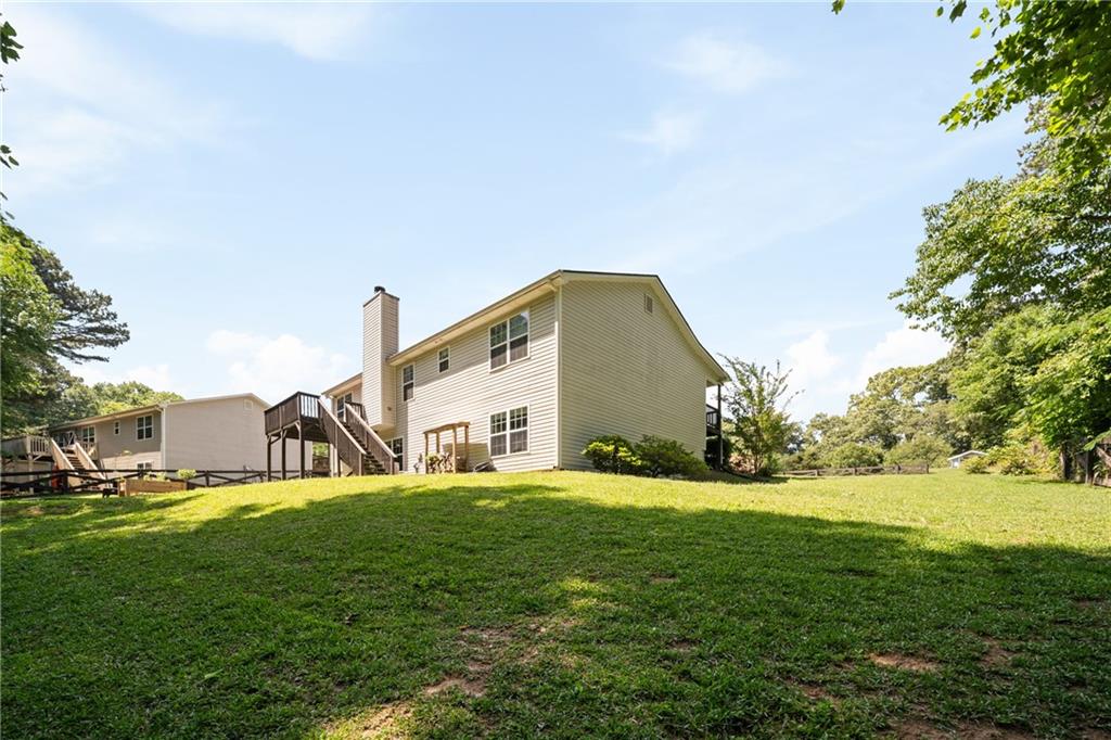 921 Pace Road Hiram, GA 30141 - Photo 28 of 41 a view of a house with a big yard and large trees