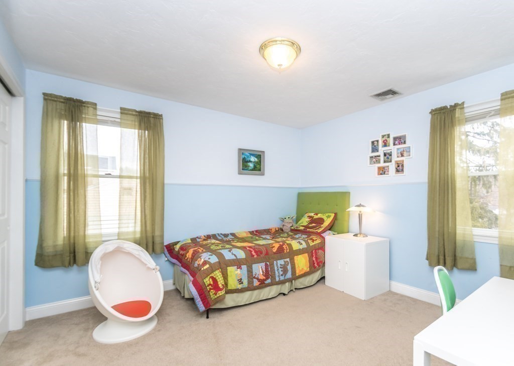 91 Brewster Road Waltham, MA 02451 - Photo 22 of 41 a bedroom with a bed and a window
