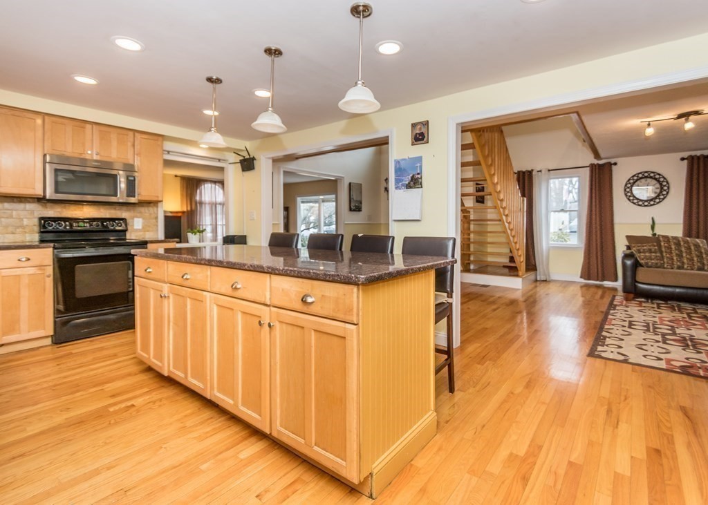 91 Brewster Road Waltham, MA 02451 - Photo 8 of 41 a kitchen with stainless steel appliances granite countertop a sink and a stove top oven