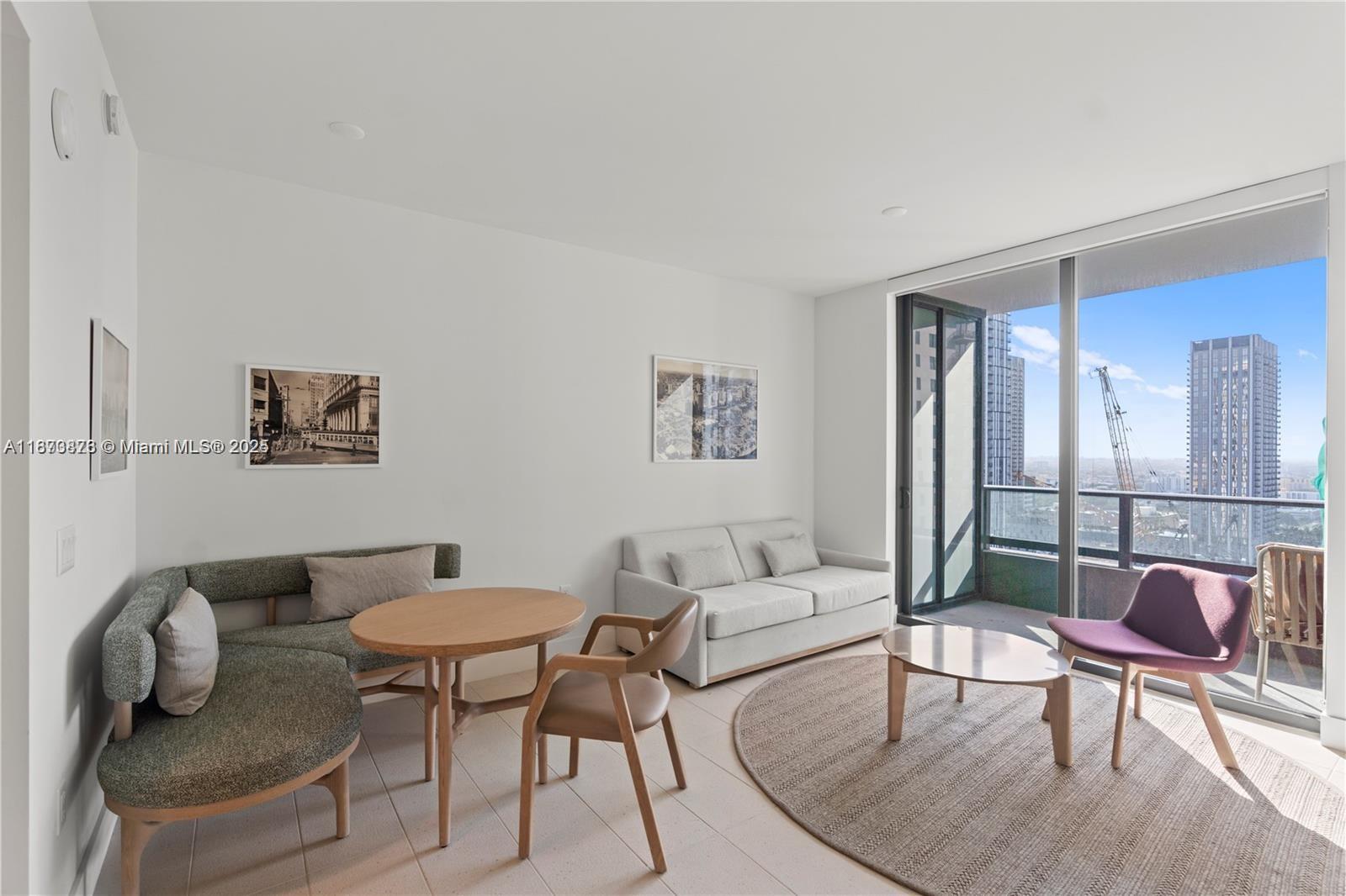 159 Northeast 6th Street, Unit 2403 Miami, FL 33132 - Photo 18 of 18 a living room with furniture and a table