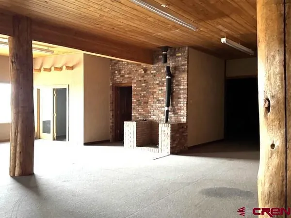 a view of an empty room with a fireplace