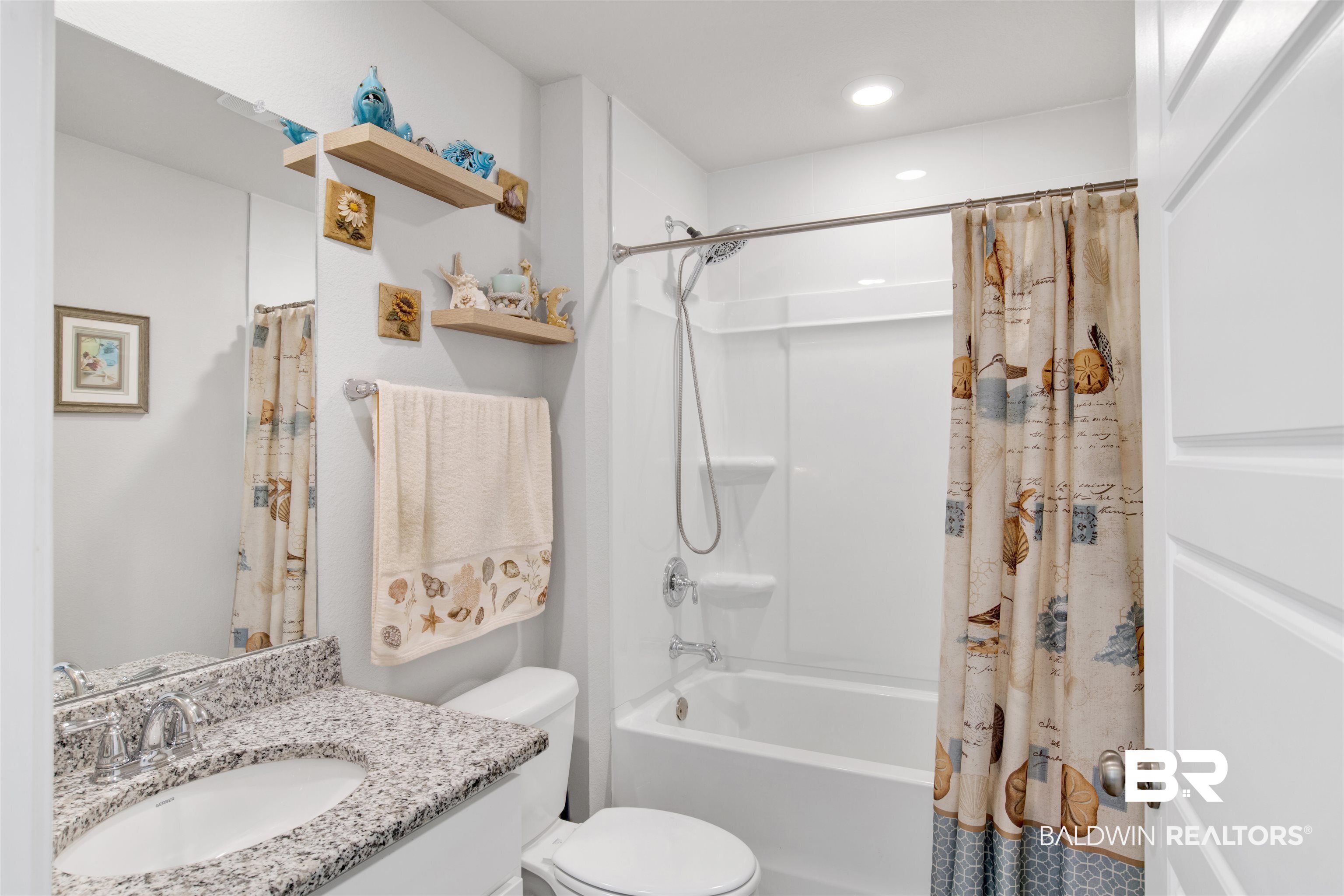 8102 Irwin Loop Daphne, AL 36526 - Photo 22 of 30 Full bathroom featuring vanity, toilet, and shower / bathtub combination with curtain