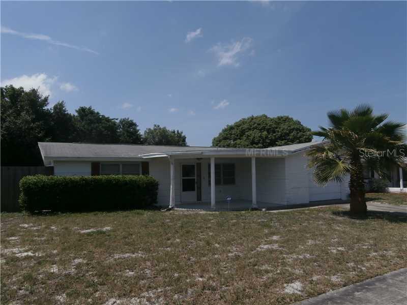 5814 Embay Avenue New Port Richey, FL 34652 - Photo 1 of 1 a front view of a house with a garden