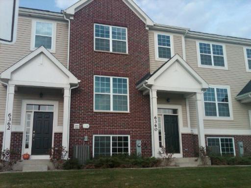 6358 Birmingham Street, Unit 104 Chicago Ridge, IL 60415 - Photo 1 of 8 a front view of a house with a yard
