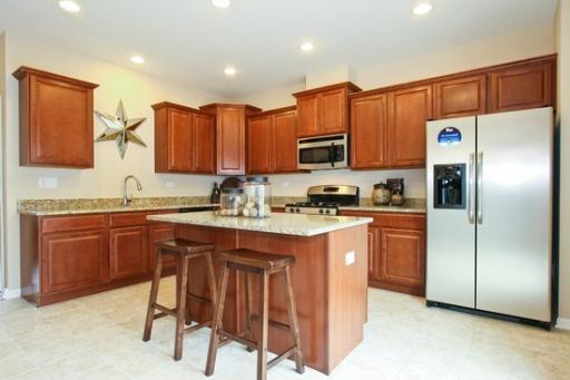 6358 Birmingham Street, Unit 104 Chicago Ridge, IL 60415 - Photo 2 of 8 a kitchen with stainless steel appliances granite countertop a refrigerator a stove a sink and a oven