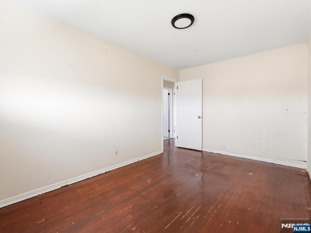 648 Fairview Avenue, Unit 2 Fairview, NJ 07022 - Photo 12 of 17 an empty room with wooden floor and windows