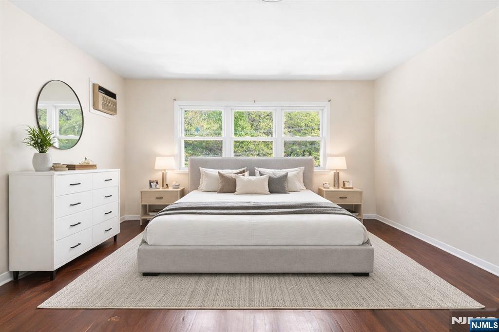 648 Fairview Avenue, Unit 2 Fairview, NJ 07022 - Photo 3 of 17 a spacious bedroom with a bed a dresser and window
