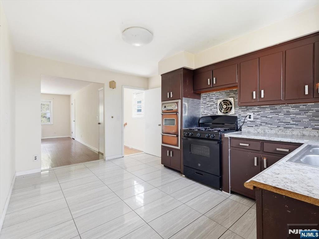 648 Fairview Avenue, Unit 2 Fairview, NJ 07022 - Photo 4 of 17 a kitchen with stainless steel appliances granite countertop a refrigerator and a stove
