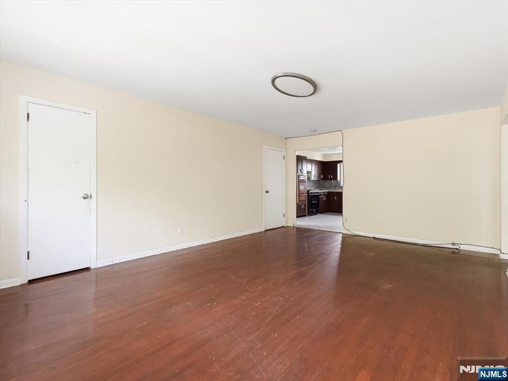 648 Fairview Avenue, Unit 2 Fairview, NJ 07022 - Photo 7 of 17 an empty room with wooden floor and windows