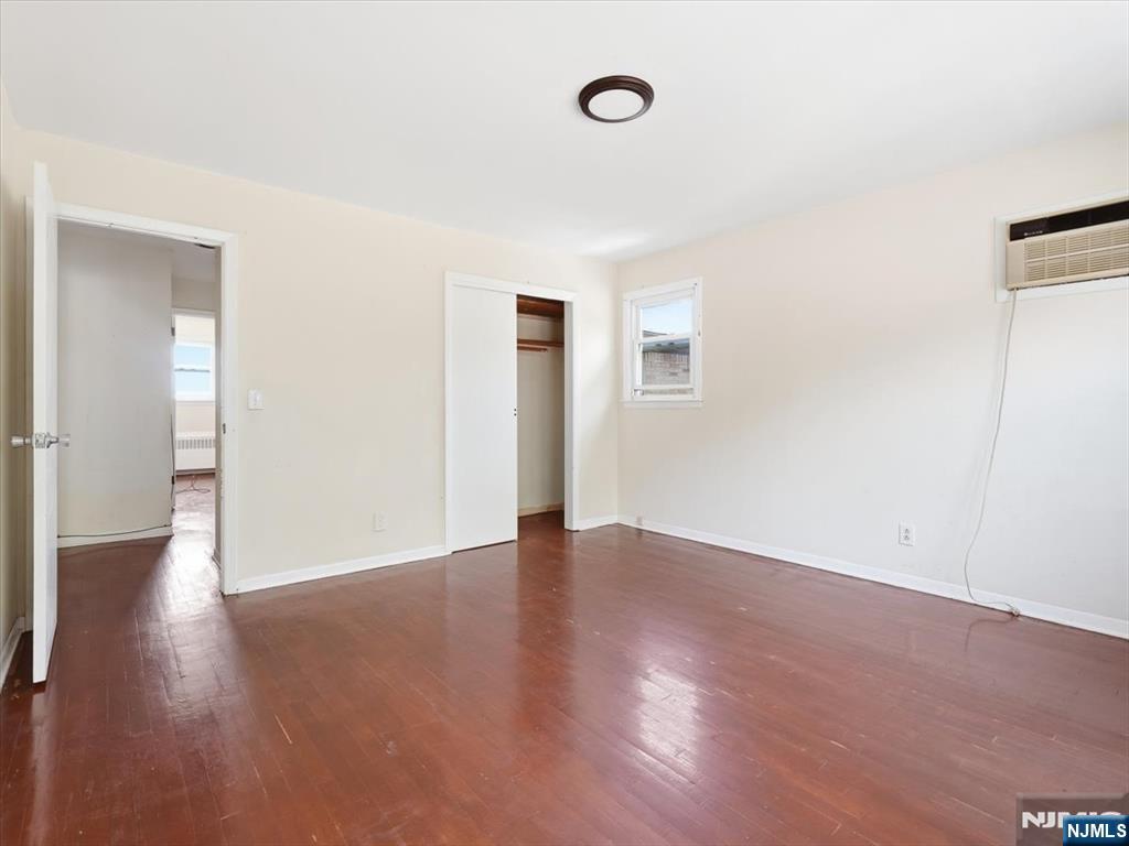 648 Fairview Avenue, Unit 2 Fairview, NJ 07022 - Photo 9 of 17 an empty room with wooden floor and windows