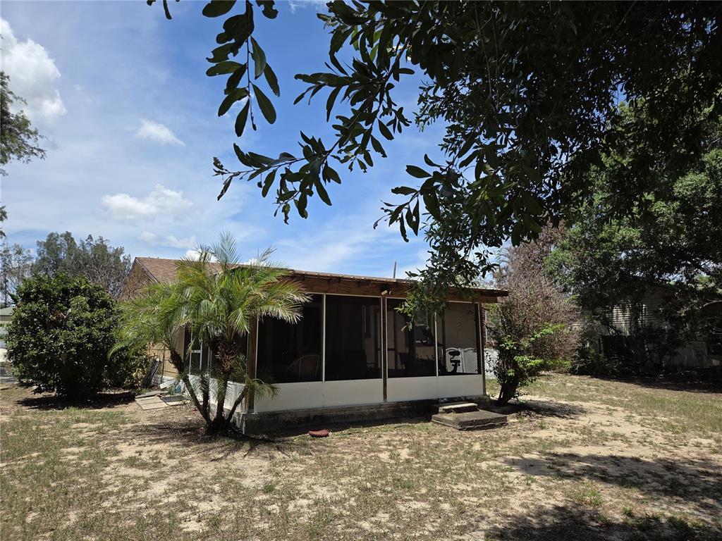 124 East F Street Frostproof, FL 33843 - Photo 33 of 37 a view of a house with a tree