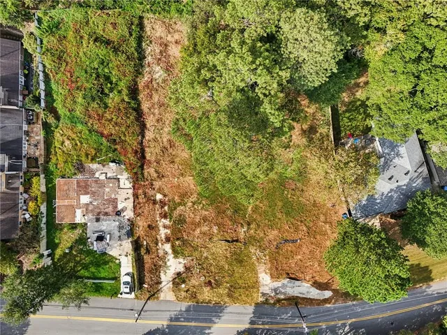 an aerial view of residential houses with yard