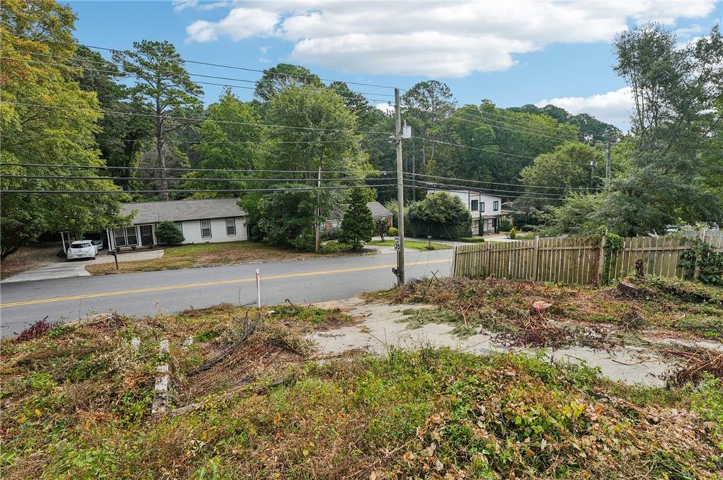 333 West Wieuca Road Northeast Atlanta, GA 30342 - Photo 8 of 8 a view of road with small yard and large trees