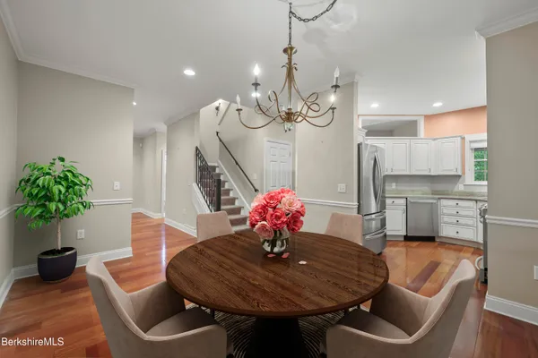 a dining room with furniture and wooden floor
