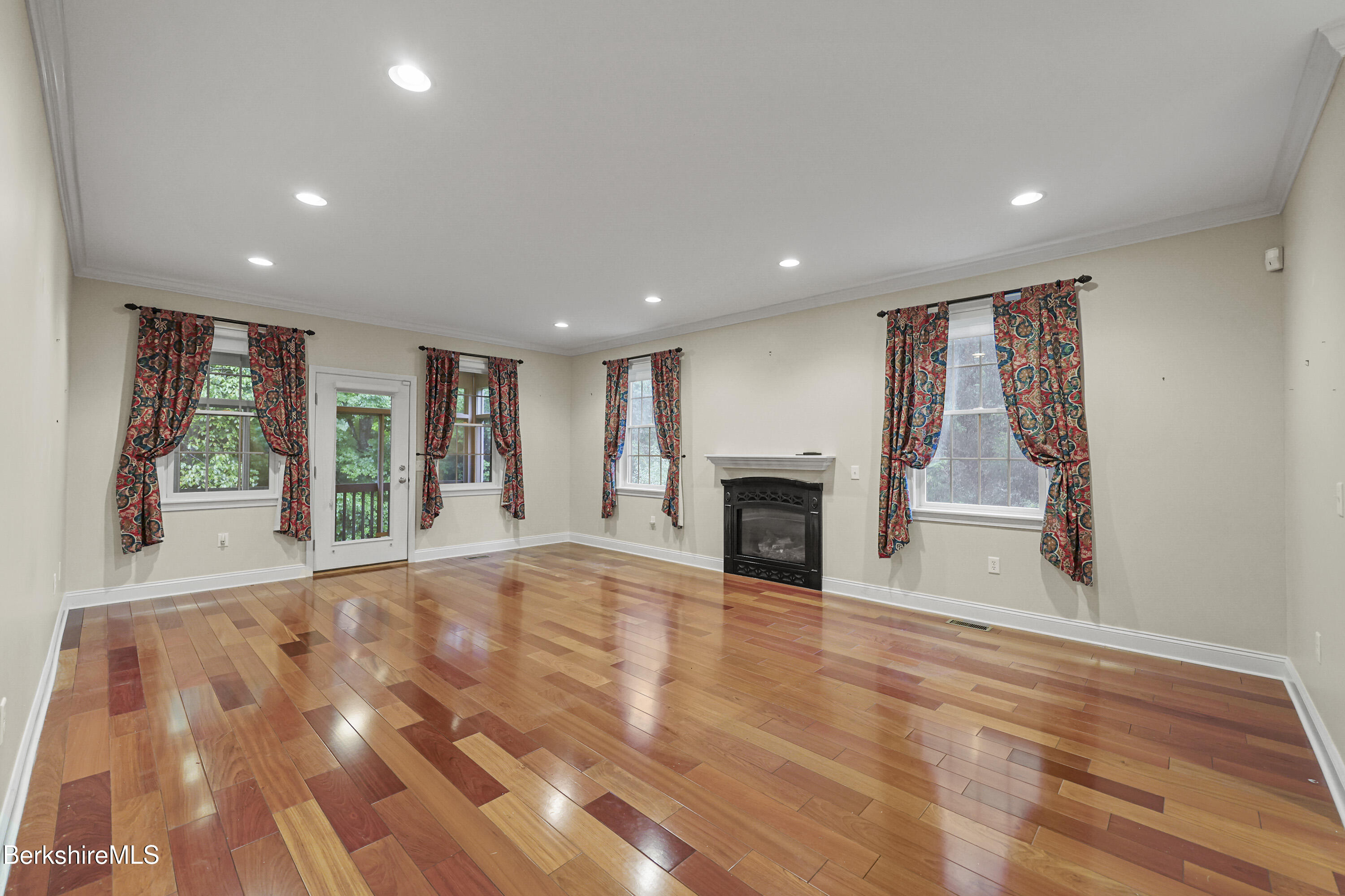 2 Amy Court, Unit 2 Pittsfield, MA 01201 - Photo 15 of 50 a view of an empty room with wooden floor and a window