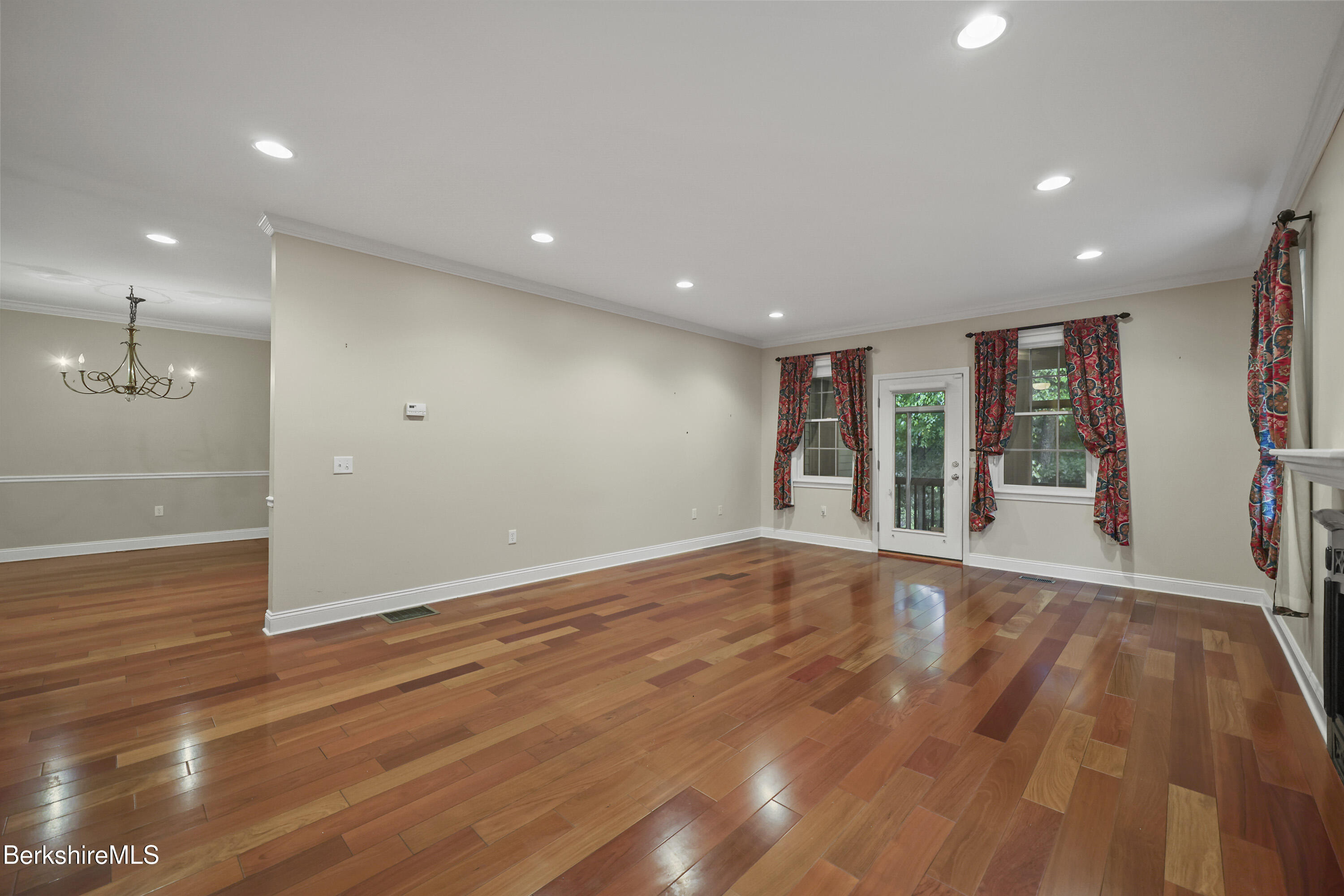 2 Amy Court, Unit 2 Pittsfield, MA 01201 - Photo 16 of 50 a view of an empty room with wooden floor and a window