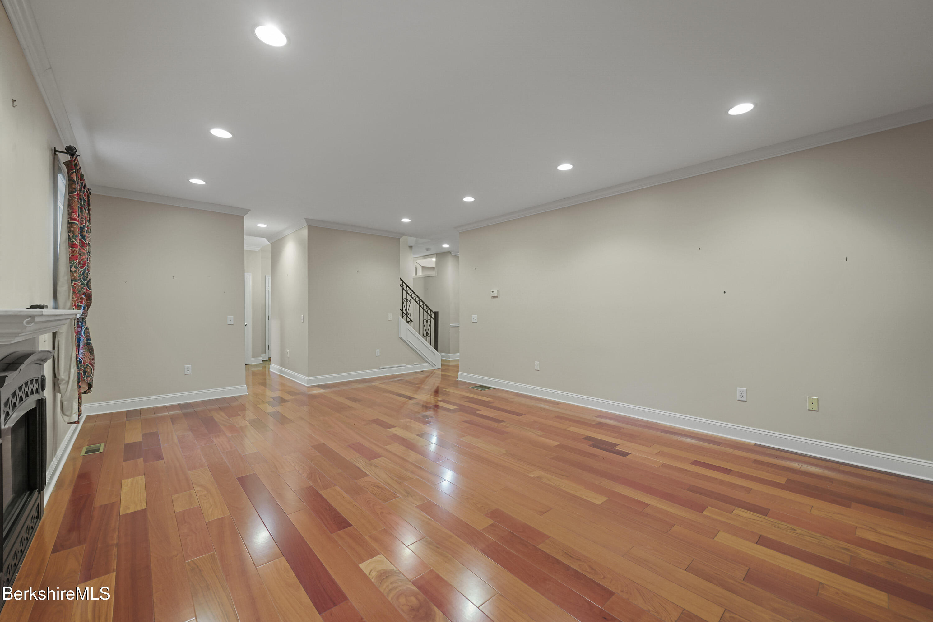 2 Amy Court, Unit 2 Pittsfield, MA 01201 - Photo 17 of 50 a view of empty room with wooden floor and fireplace