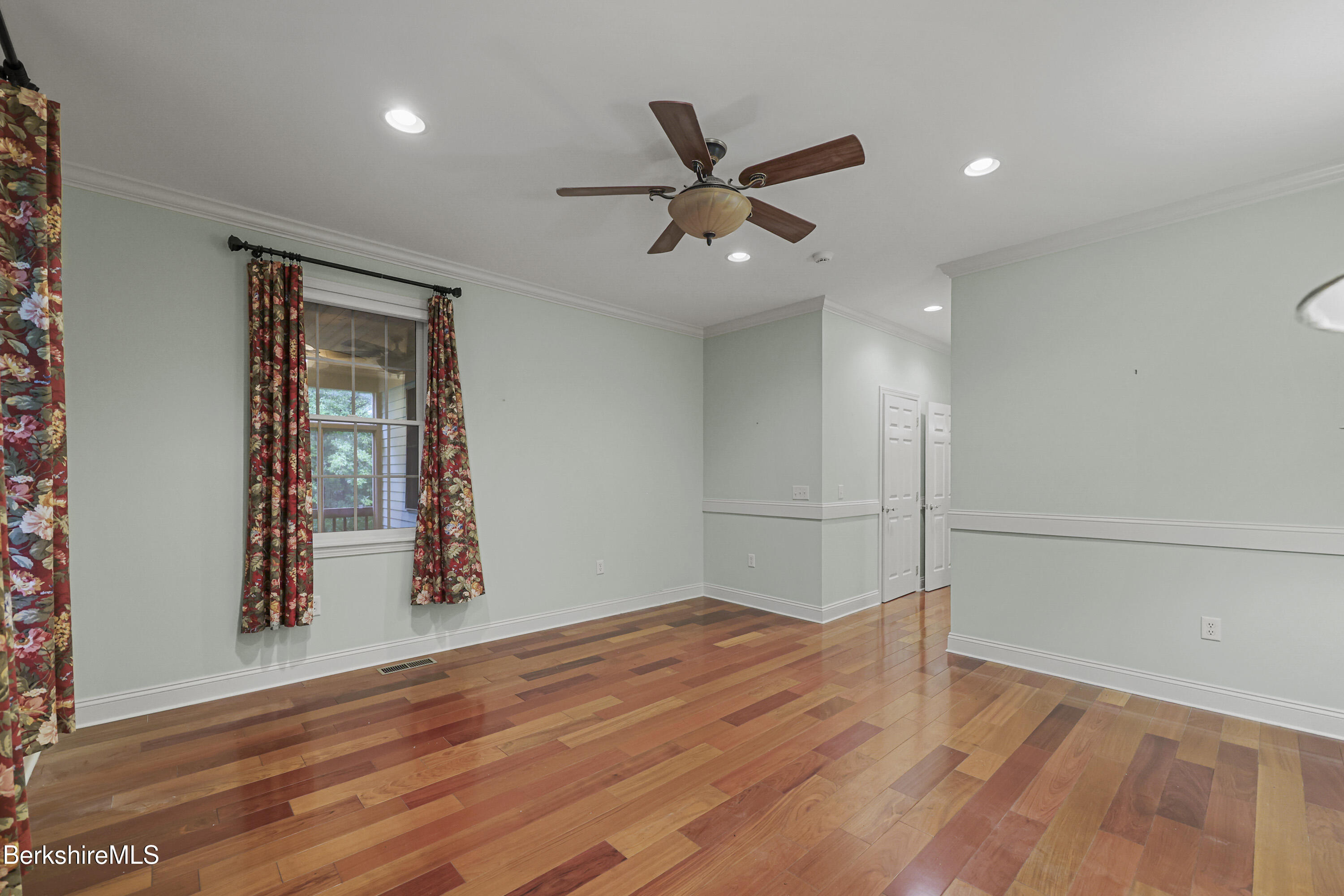 2 Amy Court, Unit 2 Pittsfield, MA 01201 - Photo 22 of 50 an empty room with wooden floor fan and windows