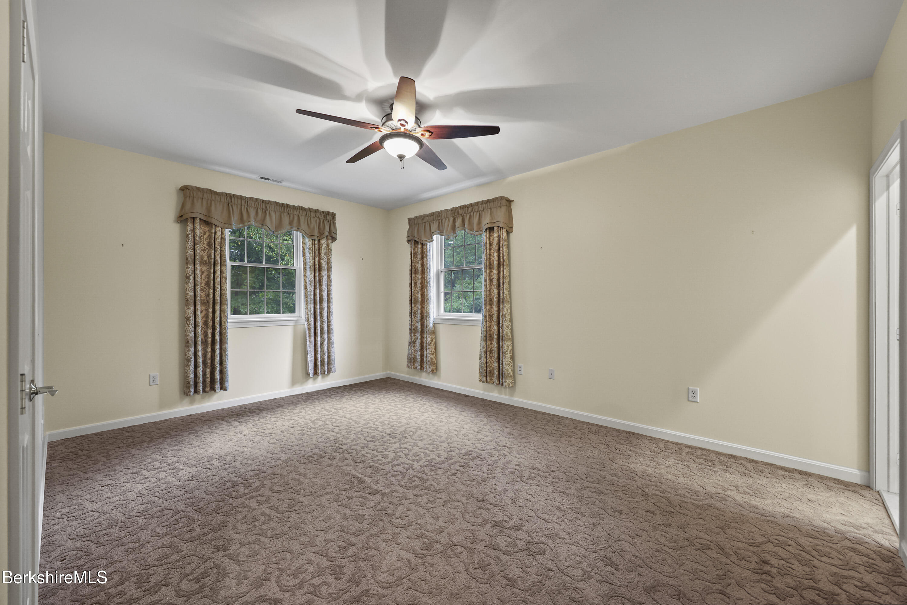 2 Amy Court, Unit 2 Pittsfield, MA 01201 - Photo 30 of 50 a view of a big room with windows and chandelier fan