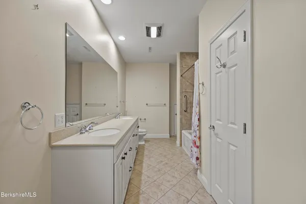 a bathroom with a sink a mirror and a shower