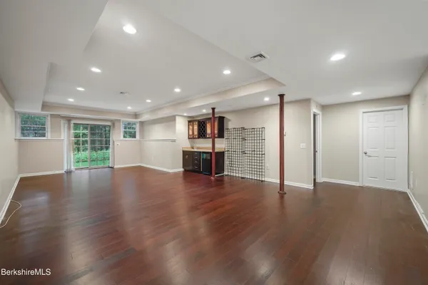 a view of empty room with wooden floor