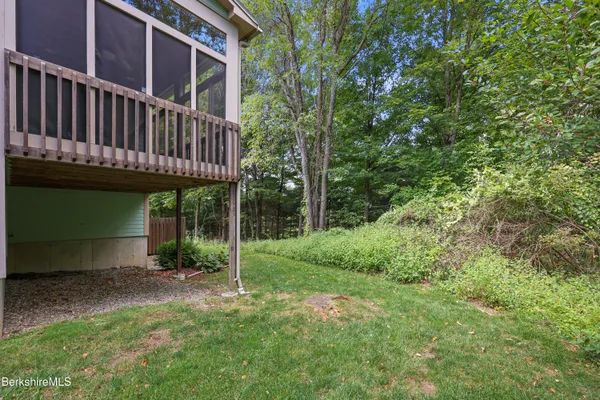 a view of a house with a yard and deck