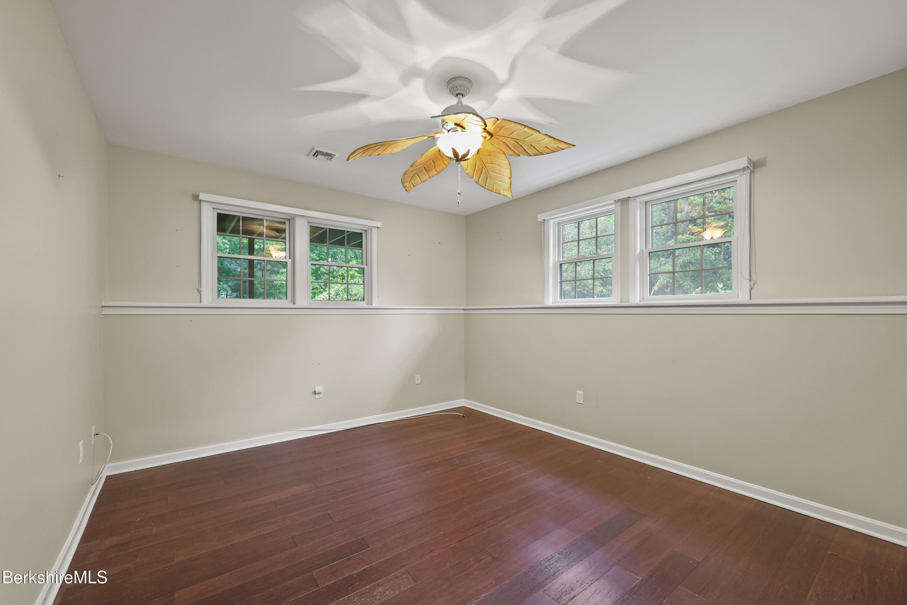 2 Amy Court, Unit 2 Pittsfield, MA 01201 - Photo 44 of 50 an empty room with wooden floor and windows