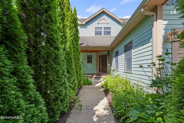 a front view of a house with garden