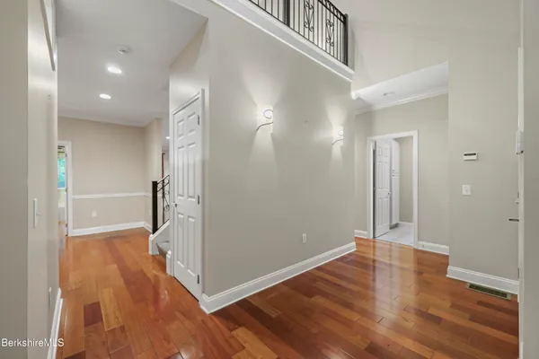 a view of a hallway with wooden floor