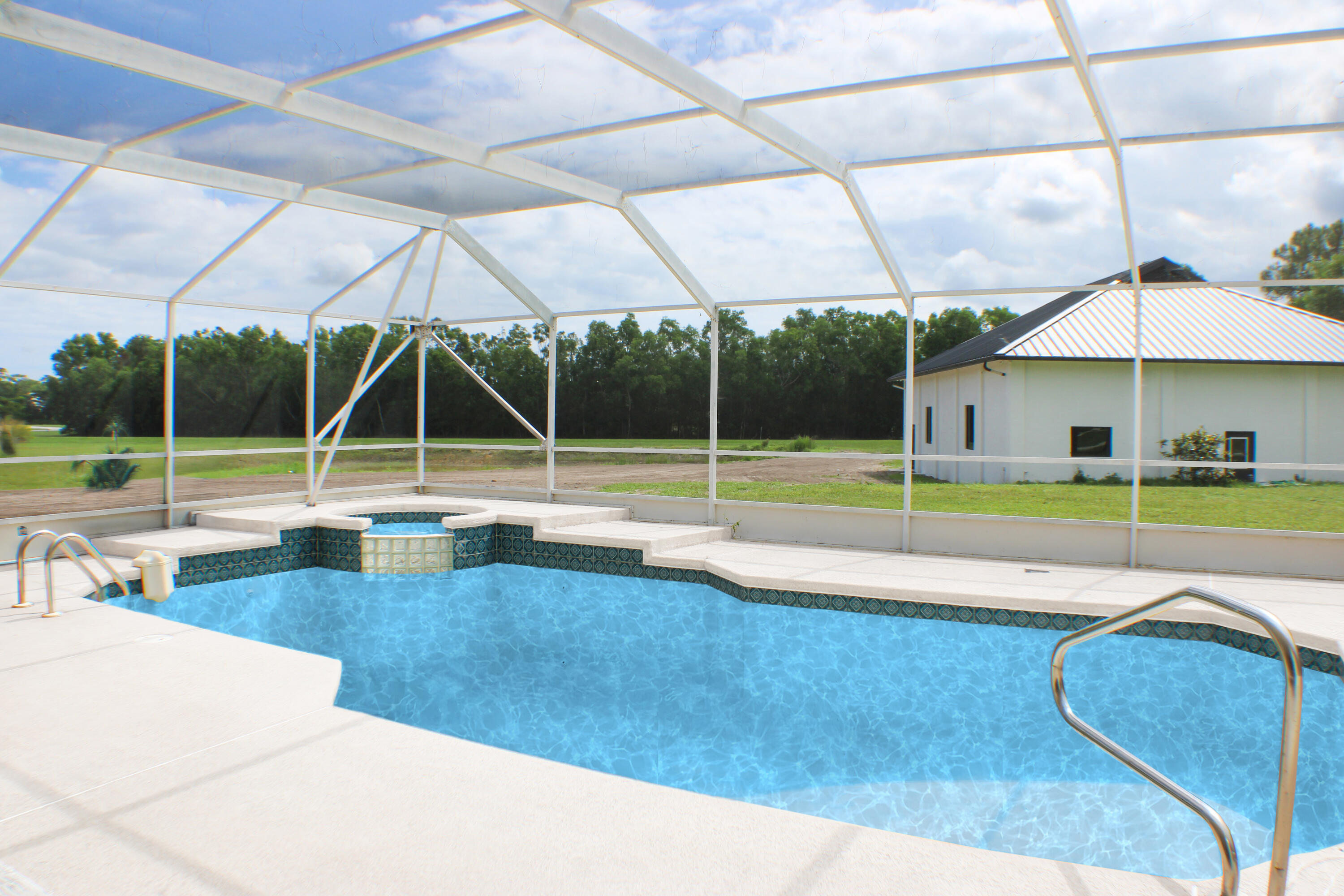18851 Mack Dairy Road Jupiter, FL 33478 - Photo 15 of 47 a view of a swimming pool with a patio